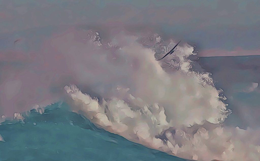 We see a hazy, partly cloudy day, with some pale teal blue piercing with the seascape, with splashing waves that reaches about a hundred feet high, and a perfect array of mist wavering in the air.