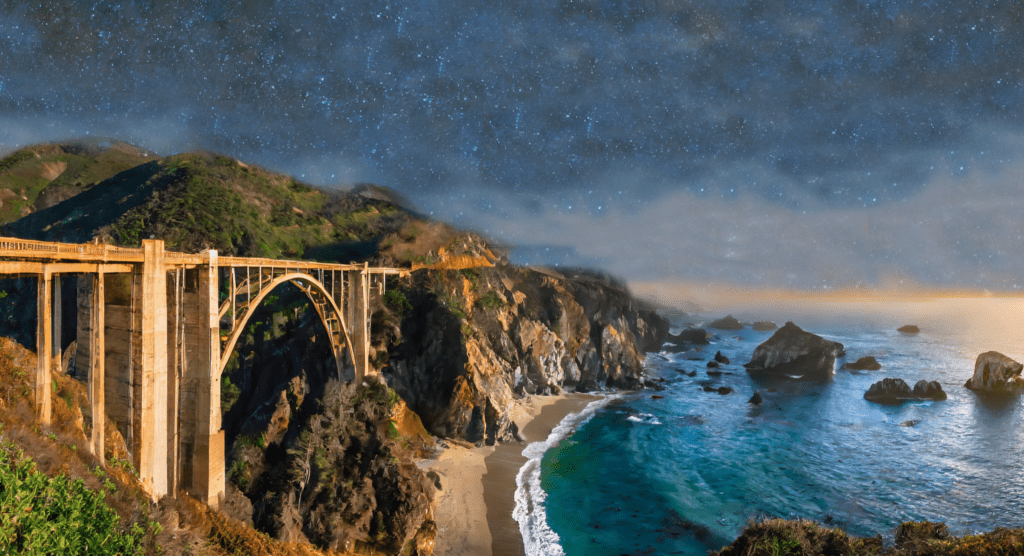 By the ocean during a cloudy sunset, seen here is the Bixby Bridge.